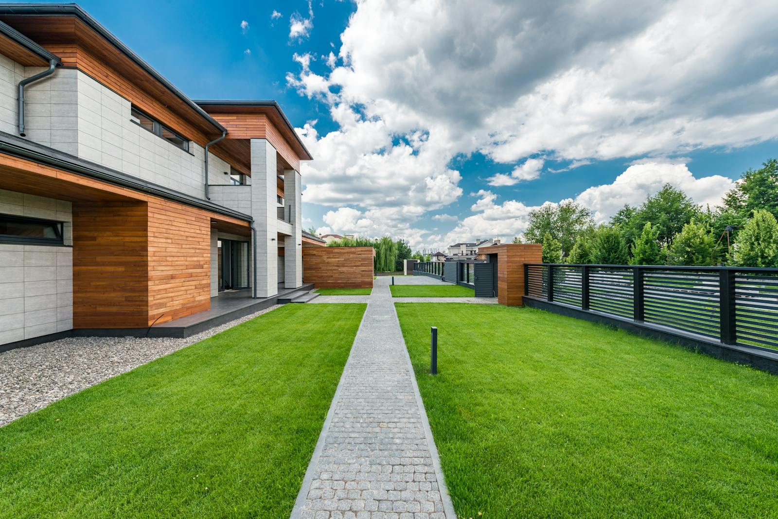 Premium modern residential home exterior with lush landscaped garden
